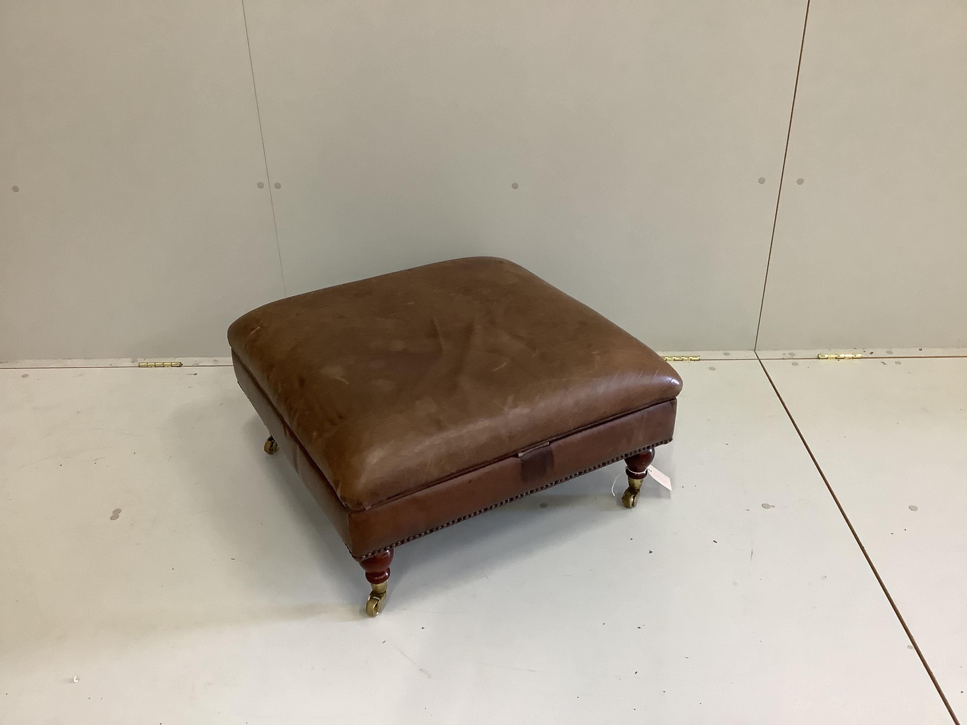 A contemporary brown leather hinged top square footstool, width 68cm, height 35cm